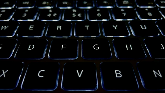a close up of a black keyboard with white letters